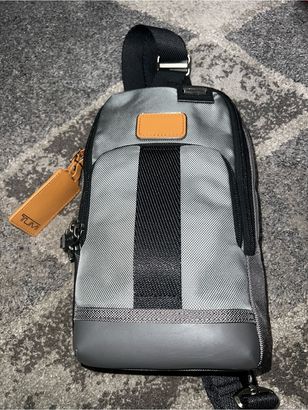 Tumi Fremont Fife Slim Sling Bag in grey ballistic nylon with tan leather accent